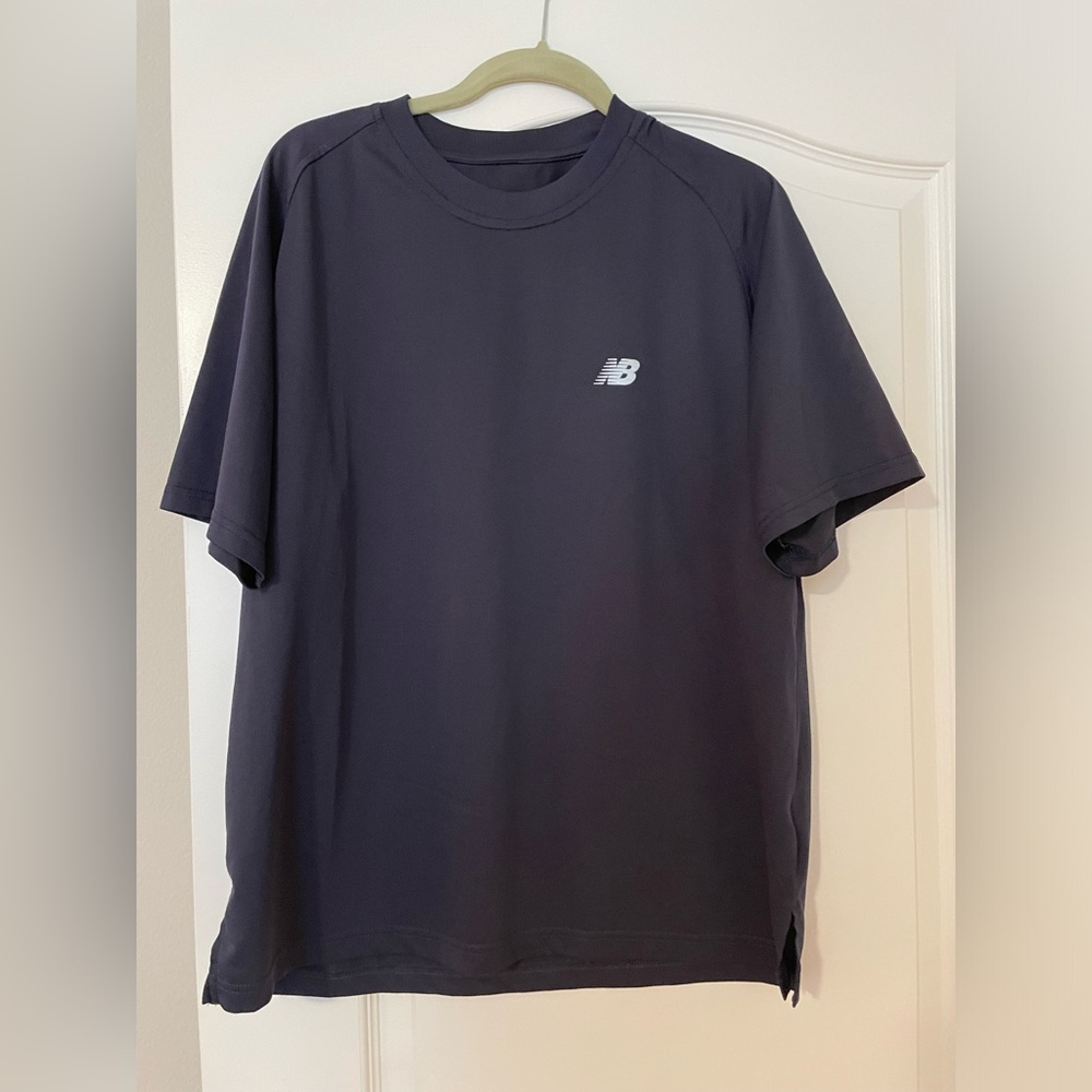 New balance men’s sport shirt. Nave blue size large. Worn once. 100% polyester